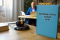 Attorney holds INTERNATIONAL TRADE LAW book. International trade lawÃÂ includes the rules and customs governingÃÂ tradeÃÂ between